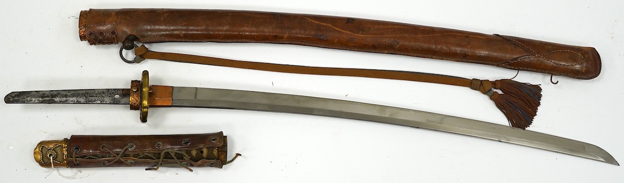 A Japanese WWII army officer’s sword Katana, blade 57.9cm, signed and dated with Seki Arsenal stamp, retaining good polish, in shin gunto mounts with leather combat cover on hilt and scabbard, the latter with plate stamp